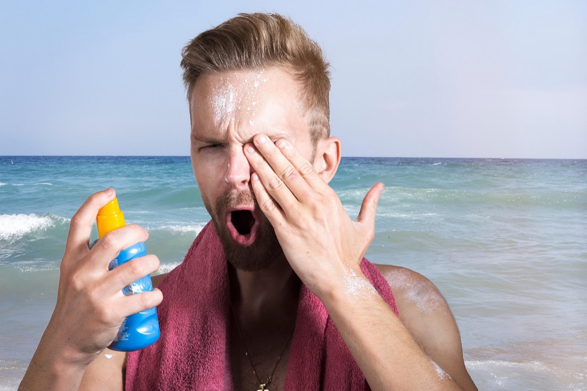 Sunscreen bottle and face under outdoor sunlight
